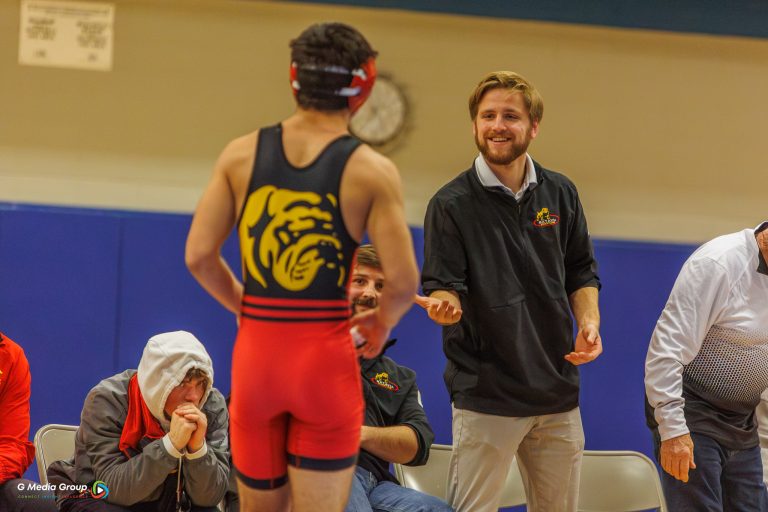 Batavia's Assistant wrestling Coach Seth Winkle congratulates Shane Fukumoto on his win.