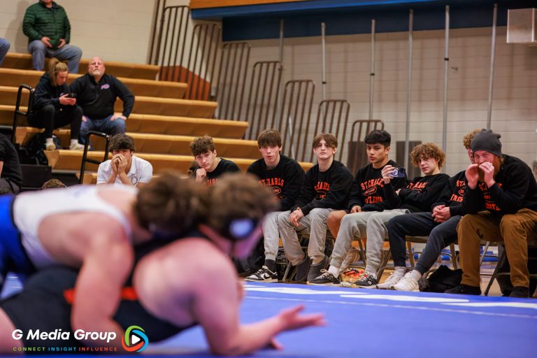 St Charles East's wrestling team watches closely during the match between Geneva's Joe Pettit and East's Matt Medina on Jan 14, 2025.