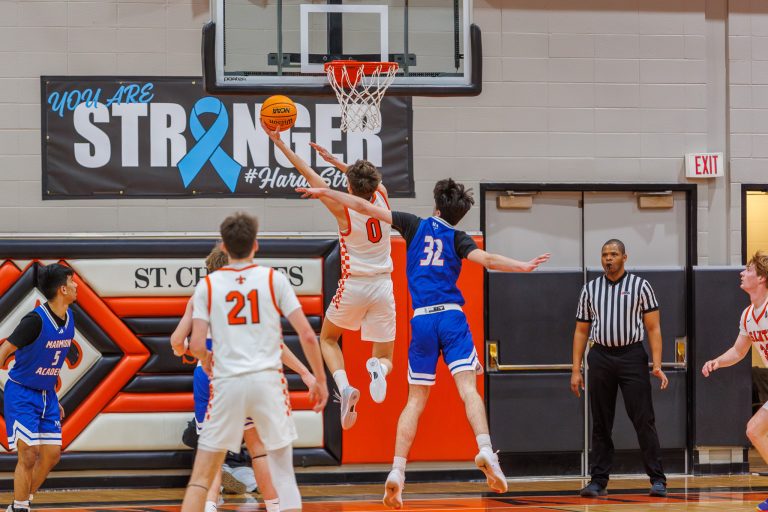 SCE's Sam Tisch makes a basket during the game against Marmion.