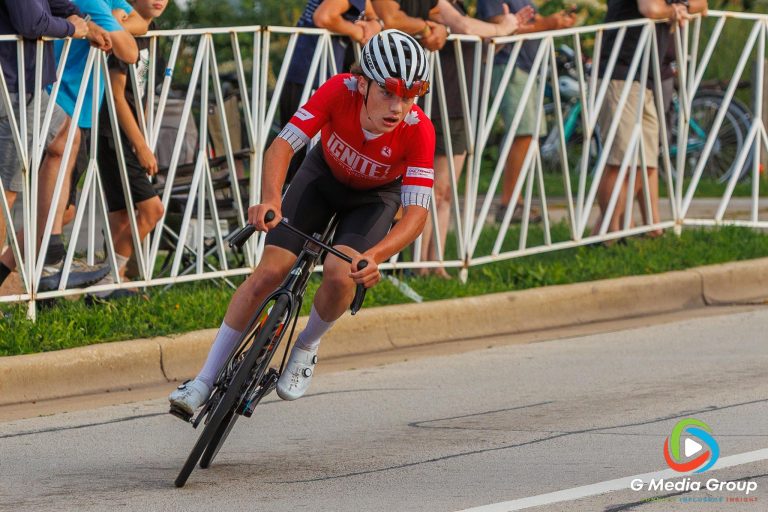 Brody Mann (18) of Ignite Junior Cycling rounds a corner during the Men’s Pro 1/2 race at the Winfield Criterium and Summerfest on Sunday, July 20, 2025, in Winfield, Ill.
