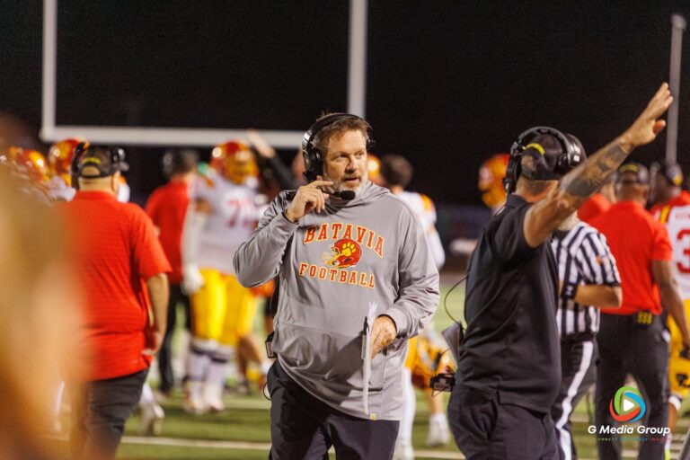 Football Head Coach Dennis Piron talks into his headset during the SCN vs Batavia High School Varsity football game on Friday September 26, 2025 at SCN. | Photo Credit: Zachary Gebis