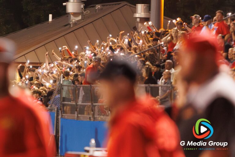 Batavia student section waves their phones flashlight from the stands in the last moments of overtime during overtime during the Geneva vs. Batavia Rivalry game at Geneva High School on October 03, 2025 | Photo credit: Zachary Gebis