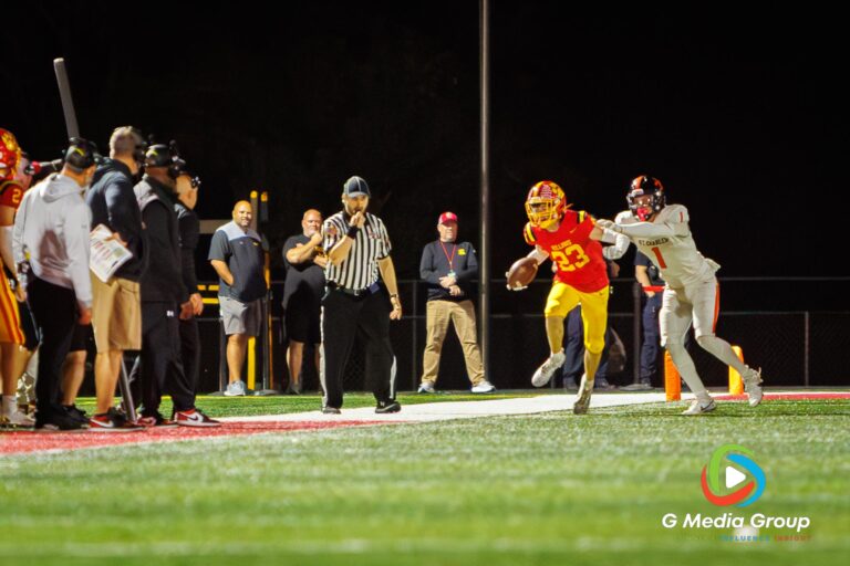 Batavia defensive back Andrew Culotta (#23) runs with the ball after securing an interception against St. Charles East wide receiver Gavin Matejko (#1) late in the fourth quarter of the DuKane Conference game on Friday, Oct. 17, 2025, in Batavia, Illinois. Culotta's late-game turnover sealed the 31-13 victory for the Bulldogs on Senior Night. (Photo Credit: Zachary Gebis)