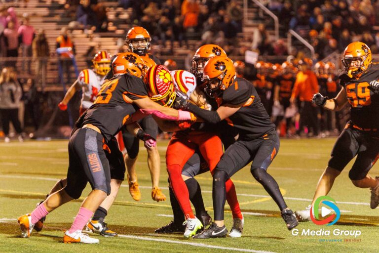 Wheaton Warrenville South players bring down Batavia's Brett Berggren (#11) during the second quarter of their matchup on Friday, October 24, 2025. The Bulldogs ultimately won the game 45-12. | Photo Credit: Zachary Gebis
