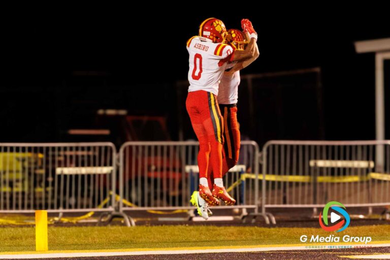 Batavia's Darin Ashiru (#0) and Brett Berggren (#11) leap to celebrate a score during their commanding 45-12 victory over Wheaton Warrenville South in a DuKane Conference game. | Photo Credit: Zachary Gebis