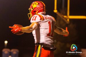 Batavia's #11 Brett Berggren (senior) celebrates after scoring the first touchdown against Wheaton Warrenville South during Friday night's DuKane Conference game. Batavia defeated Wheaton Warrenville South 45-12.