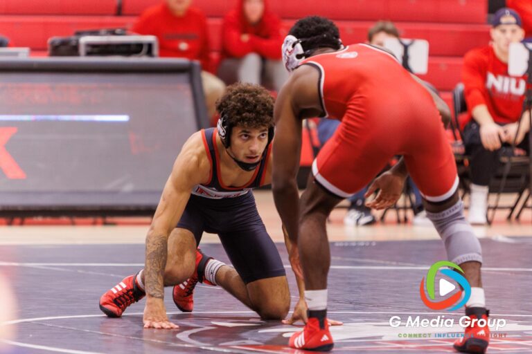 Tommy Curran (Black) squares off with Charles Curtis (Red) in a tense 141-pound match at the NIU wrestle-offs. Curtis secured the 4-1 win in sudden-victory overtime. | Photo Credit: Zachary Gebis