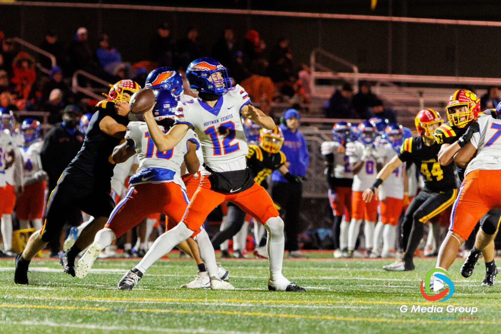 Hoffman Estates QB Austin Lezniak (12) throws a pass downfield against the Batavia defense during the first round of the IHSA Class 7A playoffs Friday night.