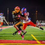 Batavia DB Elijah Gonzalez (31) secures the final touchdown of the night, despite the challenge of a Hoffman Estates defender, during the fourth quarter of the 56-0 victory in the IHSA Class 7A playoff opener.