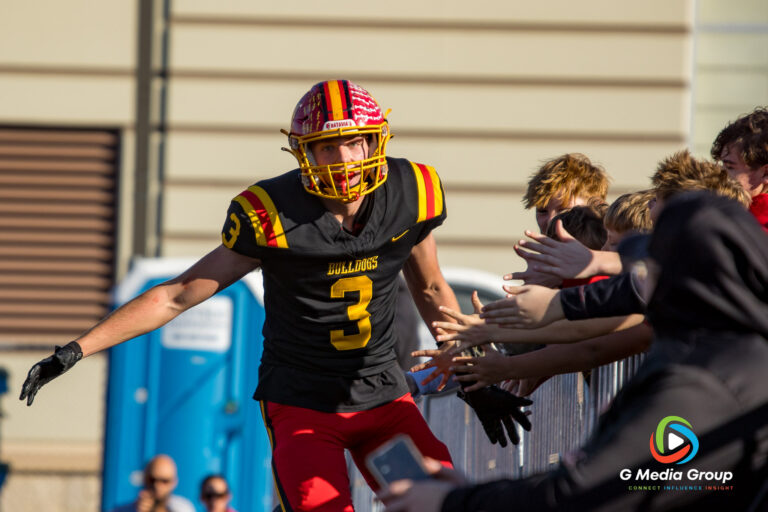 Batavia High School football player Thomas Prescott celebrates his touchdown with young fans in the end zone during the IHSA Class 7A quarterfinal game against Glenbard North, November 15, 2025. (Photo Credit - Zachary Gebis)