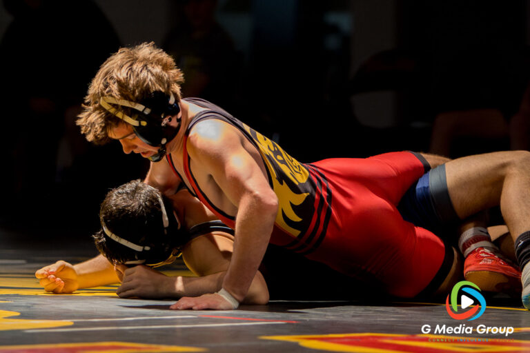 Batavia High School's Kyle Pasco (top) works to secure a pin against Lake Park High School's Luca Rutili during the 132 lbs match of a boys varsity wrestling dual meet in Batavia, Ill., on Thursday, Dec. 11, 2025. Pasco won the match by pin, earning six team points for the Bulldogs in their 43-29 victory.