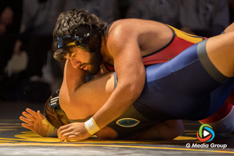 Batavia High School's Josiah Johnson works to secure a pin during the 285 lbs match of a boys varsity wrestling dual meet in Batavia, Ill., on Thursday, Dec. 11, 2025. Johnson won the match by pin, securing the final team points in the Bulldogs' 43-29 victory.
