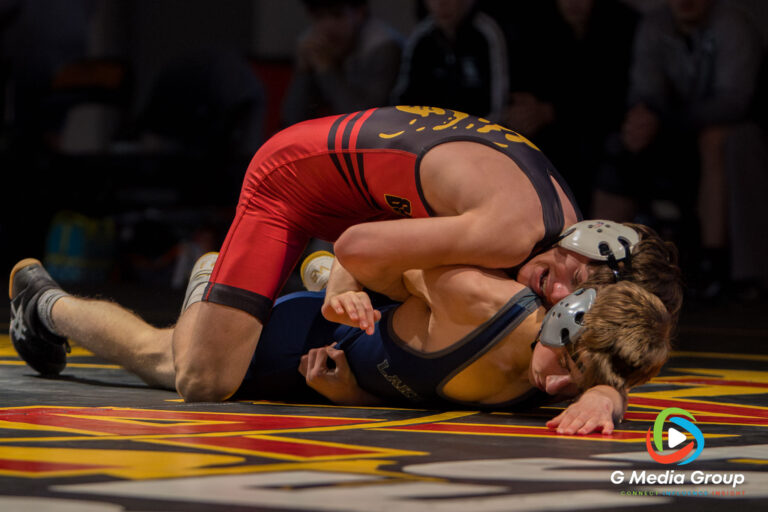 atavia High School's Kai Enos (top) controls Lake Park High School's William Blackhall (bottom) during the 126 lbs match of a boys varsity wrestling dual meet in Batavia, Ill., on Thursday, Dec. 11, 2025.