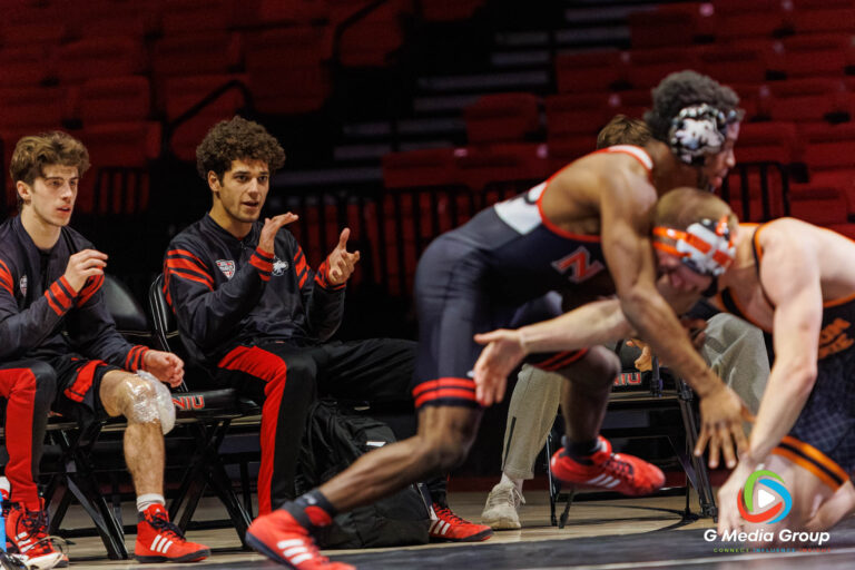 NIU's Tommy Curran and Blake West support Charles Curtis during his match against Nash Singleton of Oregon State.