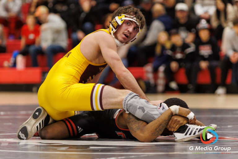 CMU's Andrew Austin (Yellow Singlet) checks the timeclock during his match against NIU's Markel Baker in DeKalb, IL on January 16, 2026. Markel won by decision 9-5. (Photo: Zachary Gebis)