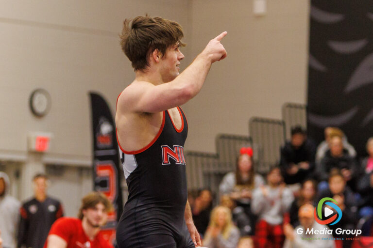 NIU's Tommy Bennett celebrates with the crowd after his 15-10 decision over CMU's Nick Marienfeld