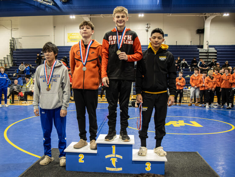 113 lbs Jack Bashore (Wheaton Warrenville South), Will Difatta (St. Charles East), Jadiel Castillo (Glenbard North), and Dylan Le (Wheaton North) are recognized on the podium during the championship round of the DuKane Conference Wrestling Championships held at Wheaton North on January 24, 2026.