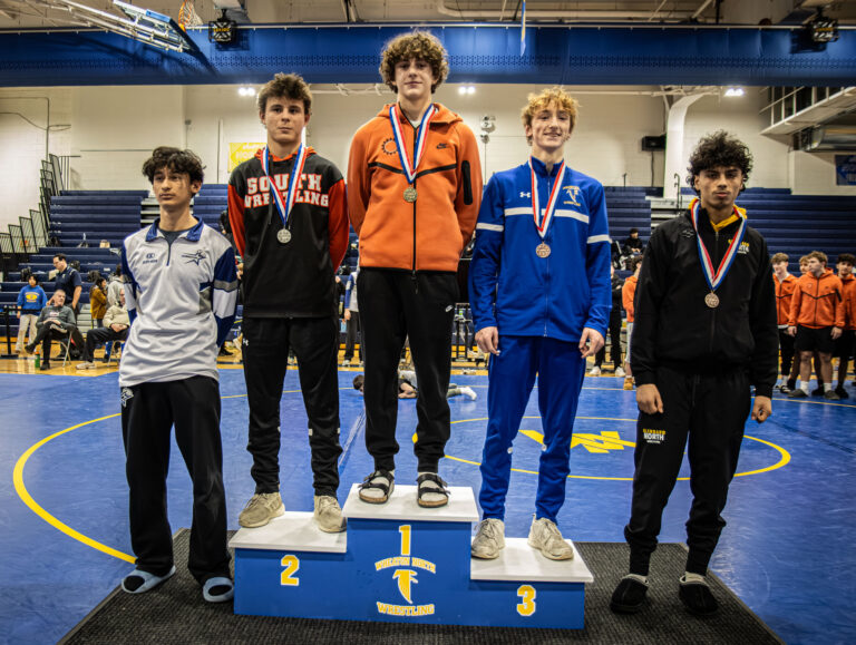 132 lbs Kaden Potter (St. Charles East), Michael Riggs (Wheaton Warrenville South), Caden Cahill (Wheaton North), Emiliano Castillo (St. Charles North), and Julian Guerra (Glenbard North) stand on the podium during the championship round of the DuKane Conference Wrestling Championships held at Wheaton North on January 24, 2026.
