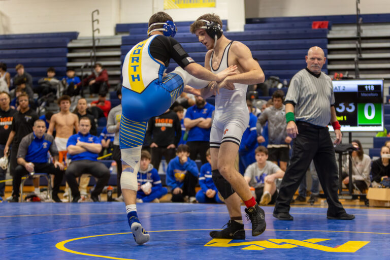 St Charles East's Liam Aye controls the leg of Wheaton North's Rocco Macellaio during the first-place match of the championship round of the DuKane Conference Wrestling Championships held at Wheaton North on January 24, 2026.