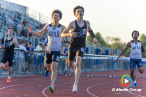 St. Charles North senior Brendan Byrne crosses the finish line just ahead of Lake Park's Wesley Bauernfreund to win Heat 2 of the Varsity Boys 300-meter hurdles at the DuKane Conference Championships on Friday, May 15, 2026. Byrne completed a sweep of the hurdles events with a winning time of 40.83 seconds, narrowly defeating Bauernfreund's 41.16 seconds.