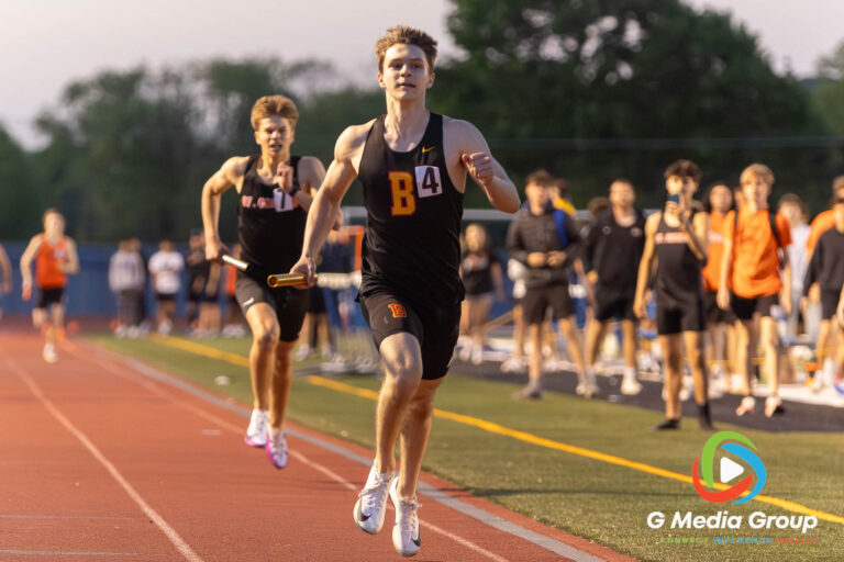 The Batavia High School anchor leg, left, crosses the finish line ahead of a surging St. Charles East runner to win the Varsity Boys 4x400-meter relay during the DuKane Conference Championships at St. Charles North High School on Friday, May 15, 2026. Batavia captured first place in the meet's final event with a winning time of 3:23.41.