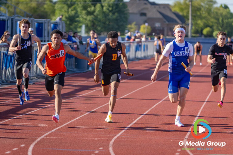 The Wheaton Warrenville South High School sprint relay team leads the field around the track to secure a victory in the Varsity Boys 4x200-meter relay during the DuKane Conference Championships at St. Charles North High School on Friday, May 15, 2026. The Tigers captured the conference crown in the event with a dominant finishing time of 1:28.89.