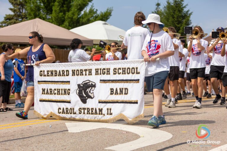 CAROL STREAM, Ill. — July 4, 2026: Participants march down the parade route during the annual Carol Stream Independence Day Parade in Carol Stream, Ill., Saturday, July 4, 2026. Despite a week-long regional heat wave, the community-funded tradition—a village staple since 1987—drew large crowds for the nearly two-hour event, which honored local military veterans as the collective Grand Marshal. (GMedia Group/Zachary Gebis)