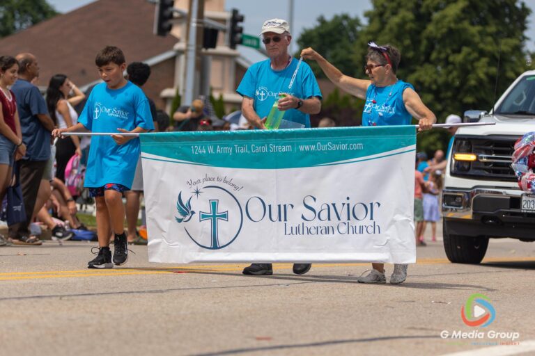 CAROL STREAM, Ill. — July 4, 2026: Participants march down the parade route during the annual Carol Stream Independence Day Parade in Carol Stream, Ill., Saturday, July 4, 2026. Despite a week-long regional heat wave, the community-funded tradition—a village staple since 1987—drew large crowds for the nearly two-hour event, which honored local military veterans as the collective Grand Marshal. (GMedia Group/Zachary Gebis)