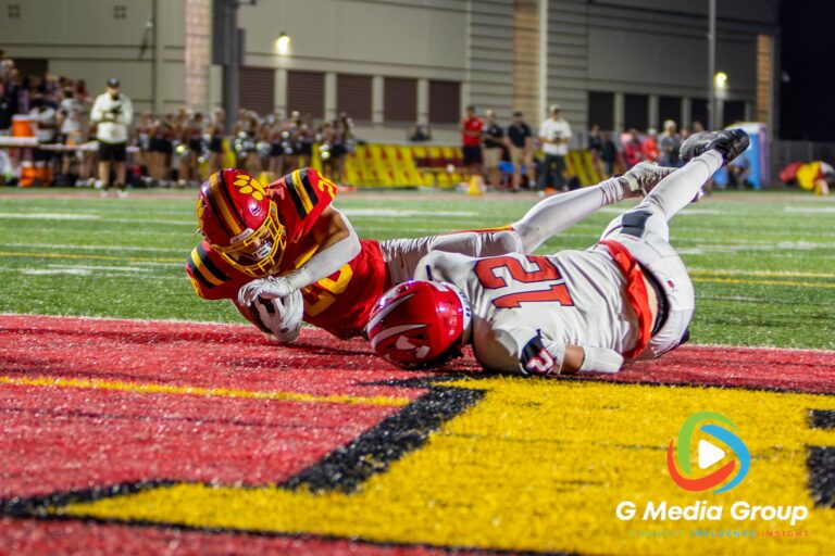 Batavia's LIAM MORAN (#28) dives into the endzone for a touchdown against Maine South in Batavia, Illinois, on August 21, 2026. The scoring play capped off a late second-quarter drive to give Batavia a 28-21 halftime advantage.