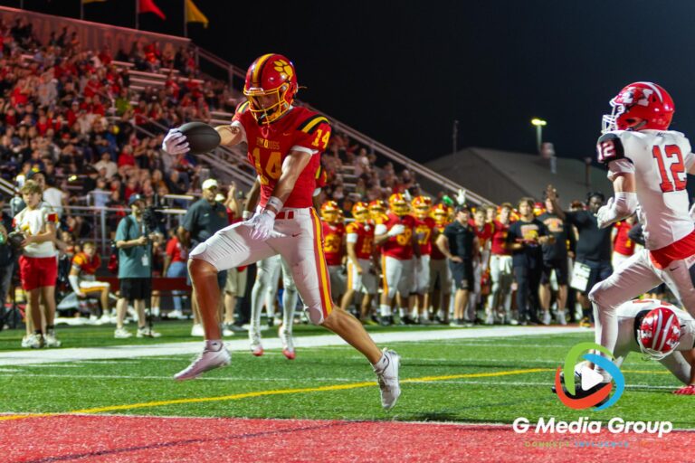 Batavia's BRENNON ZENG (#14) crosses the goal line for a touchdown during fourth-quarter action against Maine South in Batavia, Illinois, on August 21, 2026. Zeng's late score helped secure Batavia's 49-35 victory.