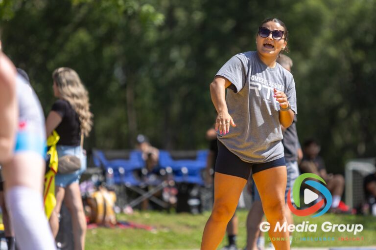 A coach from Gomez Wrestling RTC shouts instructions mat-side during the Summer Fiesta Wrestling Tournament at Carol Stream Community Park in Carol Stream, Ill., Saturday, Aug. 8, 2026. The outdoor event showcased athletes and coaches across youth, high school, and open divisions from across the region. (Photo by GMedia Group)