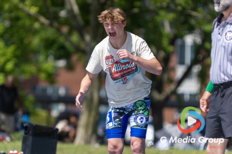 A wrestler reacts mat-side while coaching a teammate during match action at the Summer Fiesta Wrestling Tournament at Carol Stream Community Park in Carol Stream, Ill., Saturday, Aug. 8, 2026. (Photo by GMedia Group)