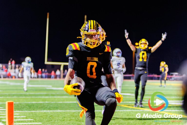 Batavia running back Darin Ashiru (0) crosses the goal line for a fourth-quarter touchdown against Geneva at Batavia High School in Batavia, Ill., on September 25, 2026. The touchdown brought Batavia within seven points late in the fourth quarter.