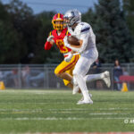 Lake Park player #9 advances the ball downfield while pursued by Batavia defender #13 during a high school football game at Batavia High School in Batavia, Ill., on September 11, 2026.