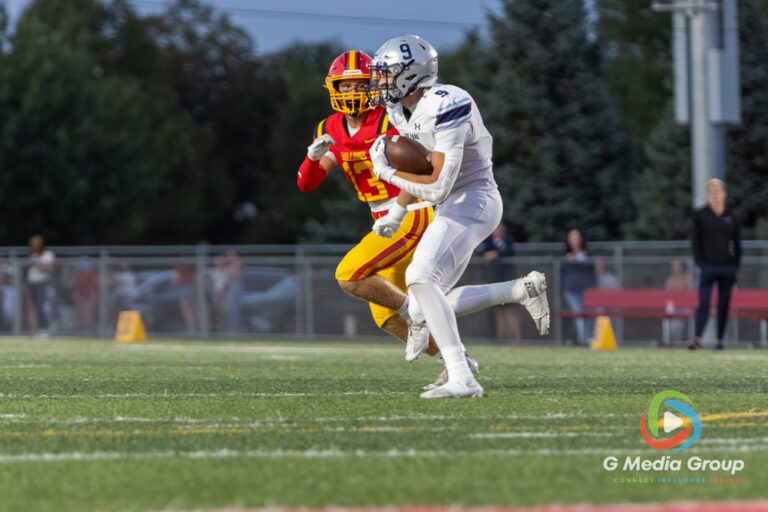 Lake Park player #9 advances the ball downfield while pursued by Batavia defender #13 during a high school football game at Batavia High School in Batavia, Ill., on September 11, 2026.