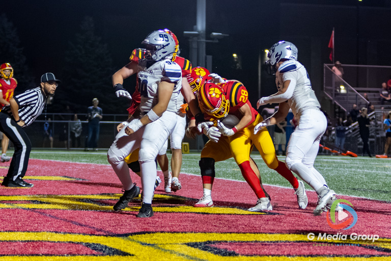 Batavia running back Liam Moran (28) pushes through the defensive line for a second-quarter touchdown against Lake Park High School at Batavia High School in Batavia, Ill., on September 11, 2026.
