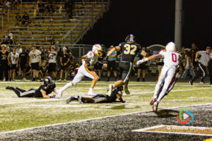 Batavia senior quarterback Michael Vander Luitgaren (#8) darts into the end zone while pursued by Glenbard North defenders during a high school football game at Glenbard North High School in Carol Stream, IL, on September 04, 2026.