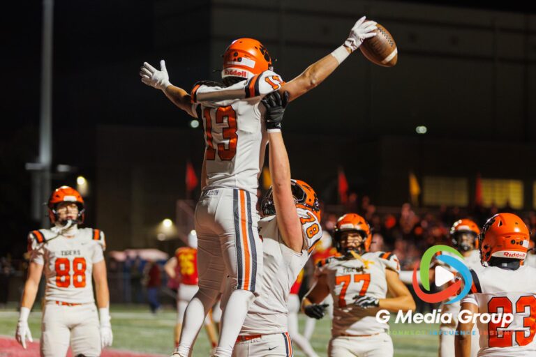Wheaton Warrenville South offensive lineman Andrew Bourne (#78) lifts teammate Blake Ittersagen (#13) in celebration following a second-quarter touchdown catch during a varsity football matchup against Batavia at Bulldog Stadium in Batavia, Illinois, on October 16, 2026.