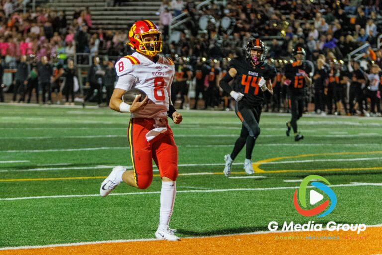 Batavia quarterback Michael Vander Luitgaren (#8) crosses into the end zone for a touchdown during the first quarter against St. Charles East on October 9, 2026. Batavia built an early lead en route to a 34-14 victory over the Fighting Saints.