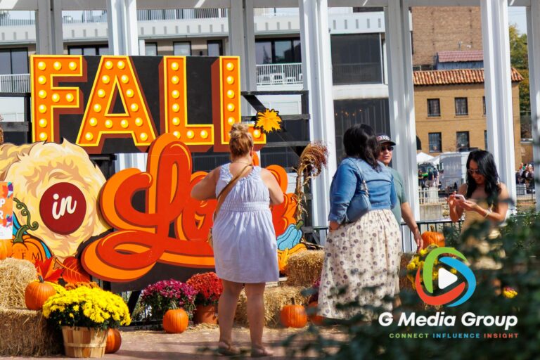 Visitors gather around the "Fall in Love" photo backdrop display during the 41st annual Scarecrow Weekend on Saturday, Oct. 10, 2026, in downtown St. Charles, Ill.